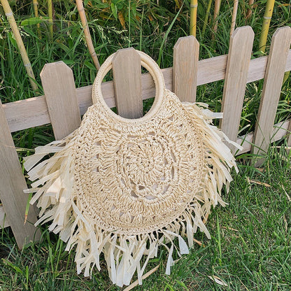 Hollow straw handbag with tassels