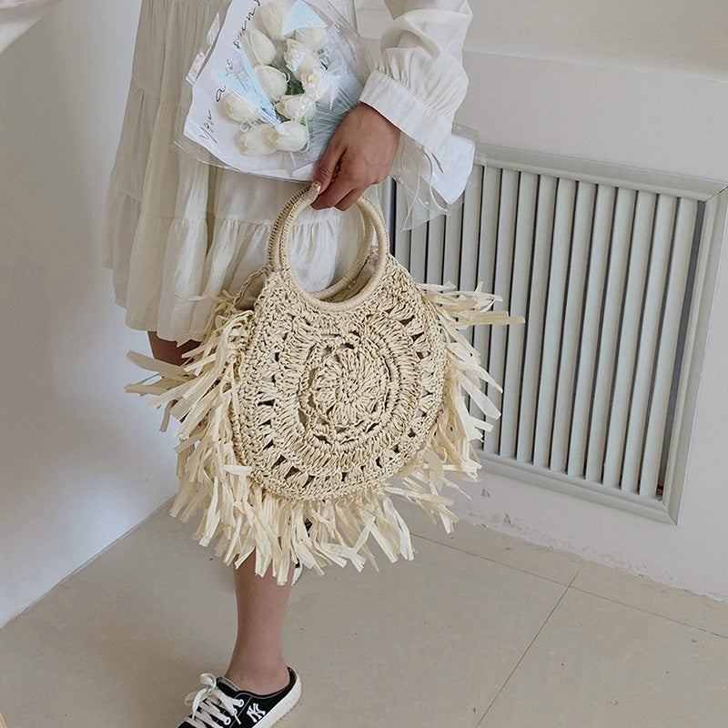 Hollow straw handbag with tassels