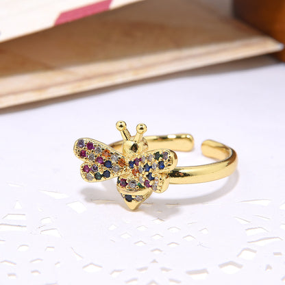 Open adjustable ladies ring in 18-carat gold with micro inlay and colored zircon