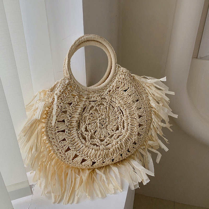 Hollow straw handbag with tassels