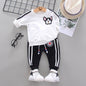 Two-piece children's suit with round neck and long sleeves made of sweater and trousers
