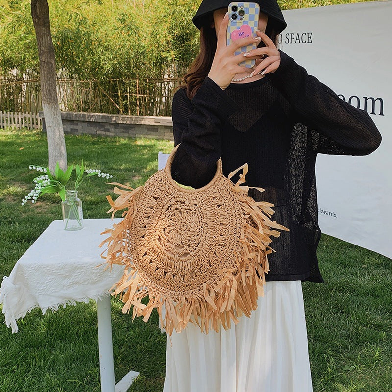 Hollow straw handbag with tassels