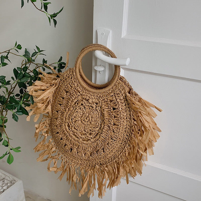 Hollow straw handbag with tassels