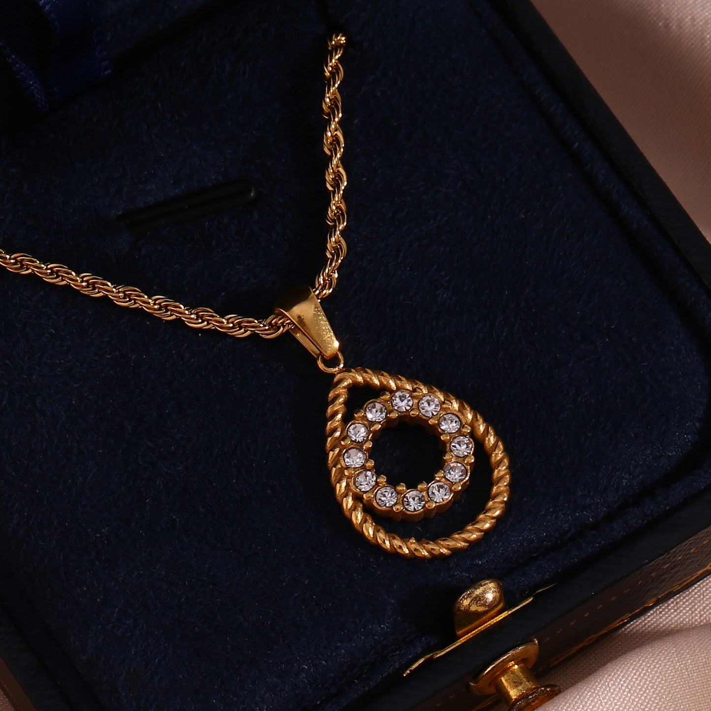 Finely inlaid ear studs with golden hollow water drop pendant necklace