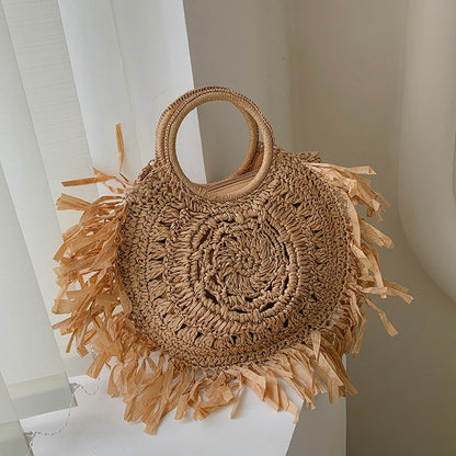 Hollow straw handbag with tassels